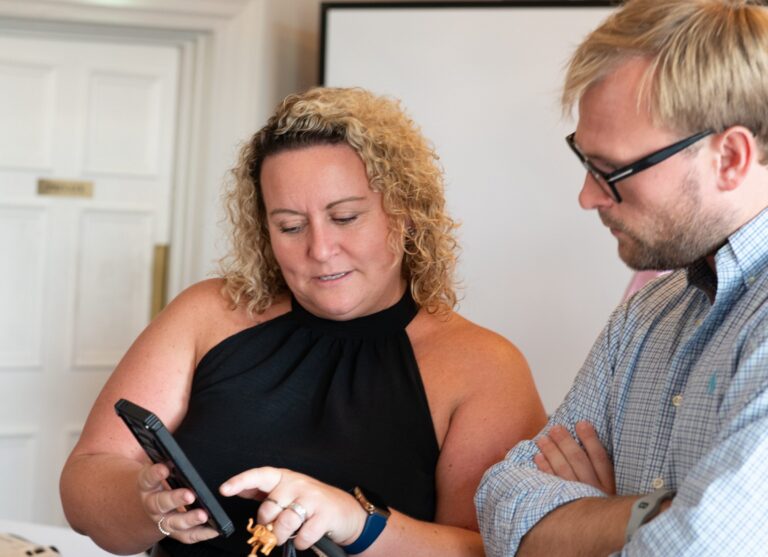 Two guests swapping details after lunch